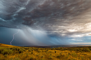Naklejka na ściany i meble Summer thunderstorm passes over the desert near Ephrata and Soap Lake in Grant County Washington