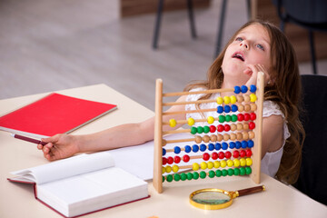 Small girl preparing for exams at home