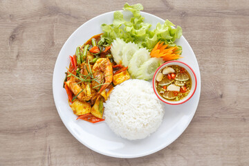 Top view Thai curry with seafood and steamed rice.