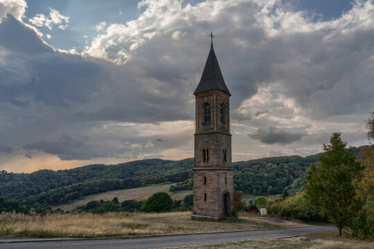 The lonely steeple of falkenstein at the donnersberg in rhineland-palatinate, Germany. The legend tells that there was no money to build the church to the tower