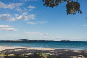 pristine serene beach view in South Hobart in Kingstome Beach with vegetation golden sand and clear water