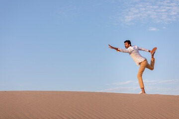 Fototapeta na wymiar a man in a desert at surise