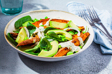 Vegan food concept. Baked sweet potato salad with avocado and edamame.