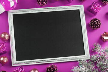 Christmas frame with New Year's toys and gifts surrounded on a pink background.