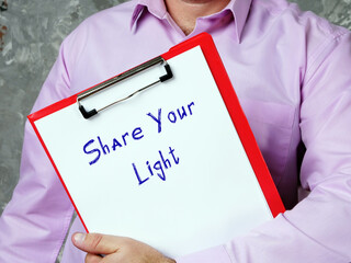 Motivational concept about Share Your Light with phrase on the page.