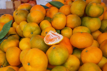 Background of ripe tangerines. Tangerines are sold at the market. Tangerines are new year's fruits, delicious and healthy citrus fruits.