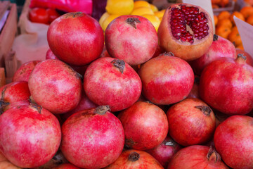 Background of ripe red pomegranates. Pomegranate are sold on the market. Punica granatum fruit close up. Of pomegranate to produce a delicious juice.
