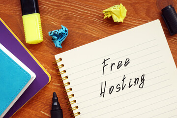 Business concept meaning Free Hosting with phrase on the piece of paper.