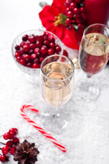 Champagne glasses with cranberry and Christmas decoration. Christmas and New Year concept.