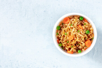 Ramen cup. Instant noodles with vegetables, overhead shot with a place for text