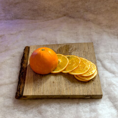 cut orange slices on a wooden pallet, preparing for Christmas, waiting for Christmas and home decorating concept