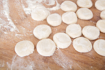 Small noodles with dumpling wrappers on the chopping board