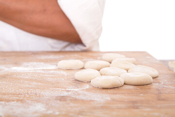 Fototapeta na wymiar There are a few white flour pancakes on the cutting board