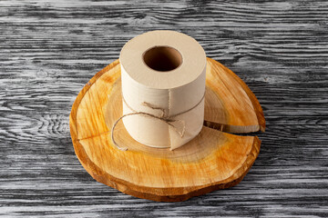 Eco-friendly bamboo toilet paper on wooden background.