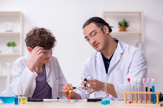 Young father and son chemists in the lab - Powered by Adobe