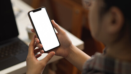 Female using smartphone while working in office room