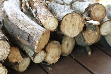 pile of firewood. stacked wood logs on wooden background