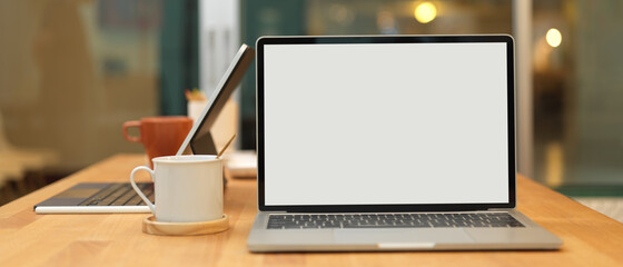 Cropped shot of meeting table with laptop and office supplies in office room
