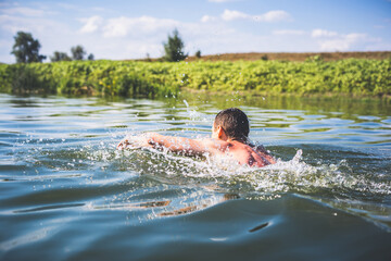 The young man swimming in the river