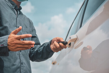 Businessman wear face mask holding key opening car door