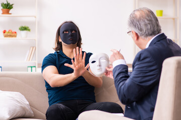 Young man wearing masks during psychotherapy session