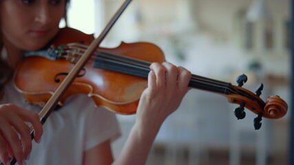 Girl playing violin with bow. Female violinist performing musical composition