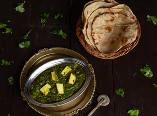 Indian Cuisine Palak Paneer Served With Tandoori Roti on Vintage Wooden Background