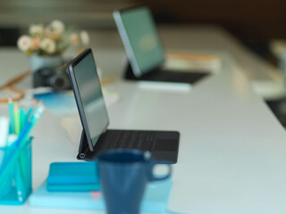 Meeting table with two tablet, stationery and office supplies in modern office room