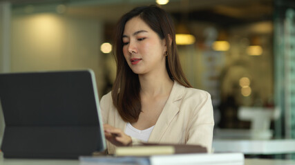 Fototapeta na wymiar Businesswoman working with tablet in modern office room