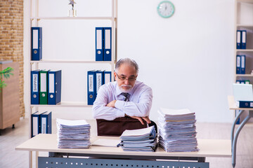 Old male employee unhappy with excessive work in the office