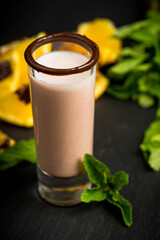 Alcohol cocktail in shot glass with chocolate liqueur, vodka, oranges and mint leaves. Selective focus. Shallow depth of field. 
