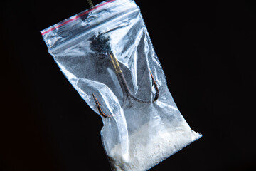 drug trap concept: drug bag with triple hook inside