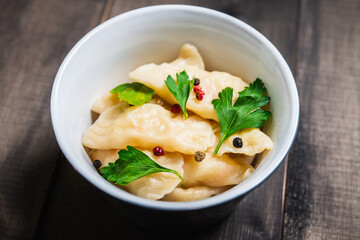 Vareniki Russian national kitchen. Boiled Russian dumplings in bowl. Selective focus. Shallow depth of field. 