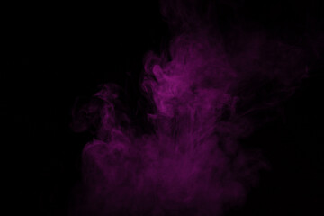 Colorful smoke close-up on a black background. Blurred pink cloud of smoke.