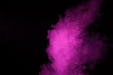 Colorful smoke close-up on a black background. Blurred pink cloud of smoke.