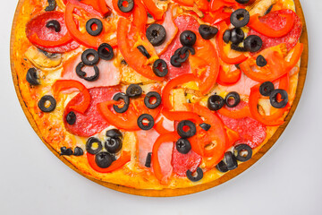 Pepperoni pizza on a white background. Traditional Italian pizza with tomatoes and meat isolated on white.