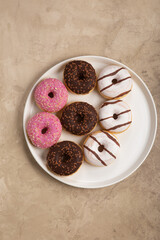 colorful donuts on rustic textured background