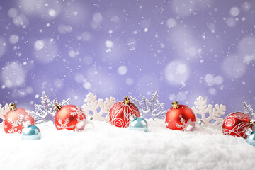 Fototapeta na wymiar Christmas red balls with snowflakes on purple background