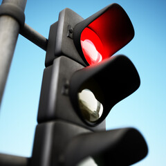 Traffic lamp with red light on against blue background. 3D illustration
