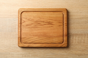 Kitchen board on wooden background, space for text