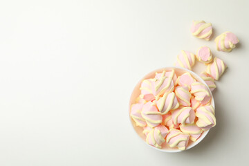 Bowl with marshmallow on white background, top view