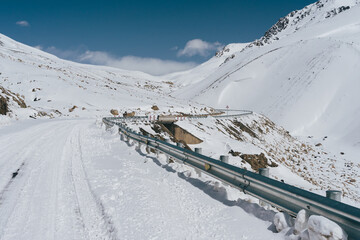 Karakoram highway covered by fresh snow, road to khunjerab pass border between Pakistan and China in winter season