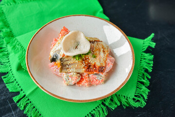 Sea food salad with smoked salmon, tomatoes, pepper and sesame seeds. Restaurant food.