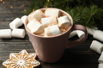 Cup with marshmallow on wooden background with Christmas accessories
