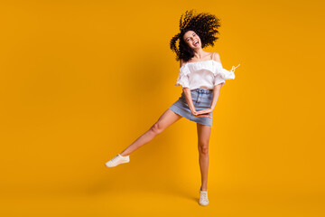 Fototapeta na wymiar Photo of sweet funny brunette woman jumping wear white top blue skirt isolated on vivid yellow color background
