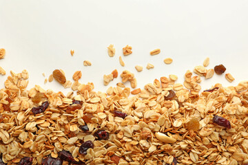 Granola with nuts and raisins on white background
