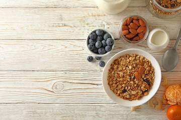 Concept of tasty breakfast with granola on wooden background