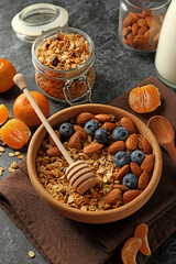Concept of tasty breakfast with granola on black smokey background