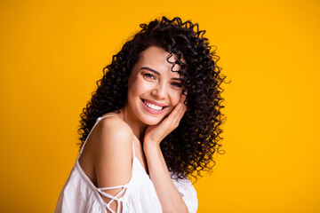 Close up profile portrait of cute optimistic brown long hairdo young lady holding head wear white top isolated on yellow color background © deagreez