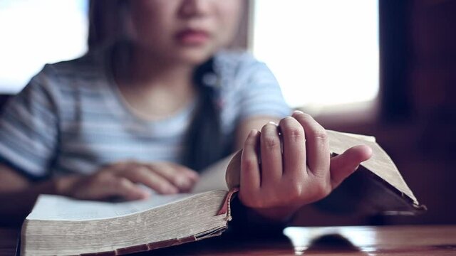 Close up hands of woman reading the Bible at home, church in home, Home church during quarantine coronavirus Covid-19, Religion concept
